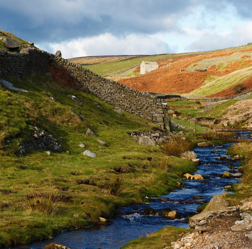 dry stone wall next to stream